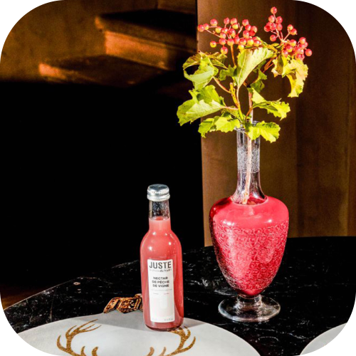 Bouteille en verre de nectar de pêche de vigne de couleur bordeaux 25 cl de face table fêtes vase -  Juste le Choix du Fruit